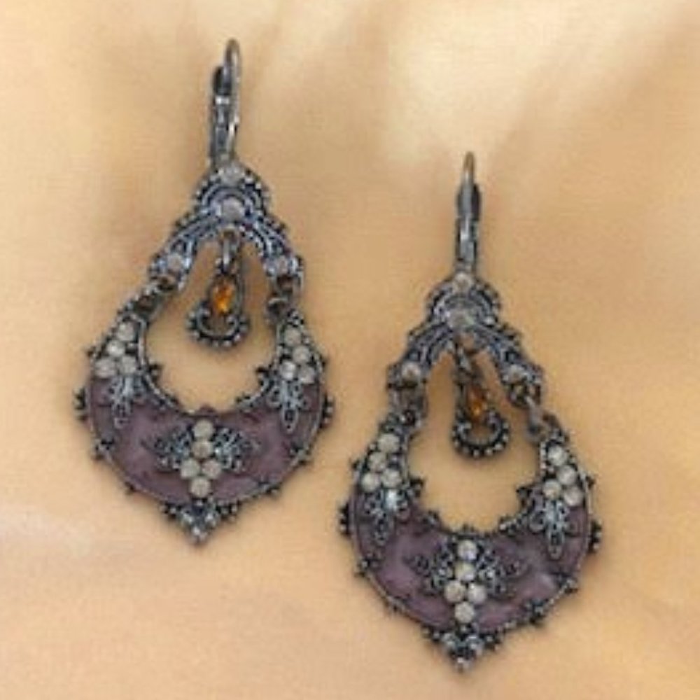 Teardrop shaped, gold tone earrings with rhinestones and detailed design